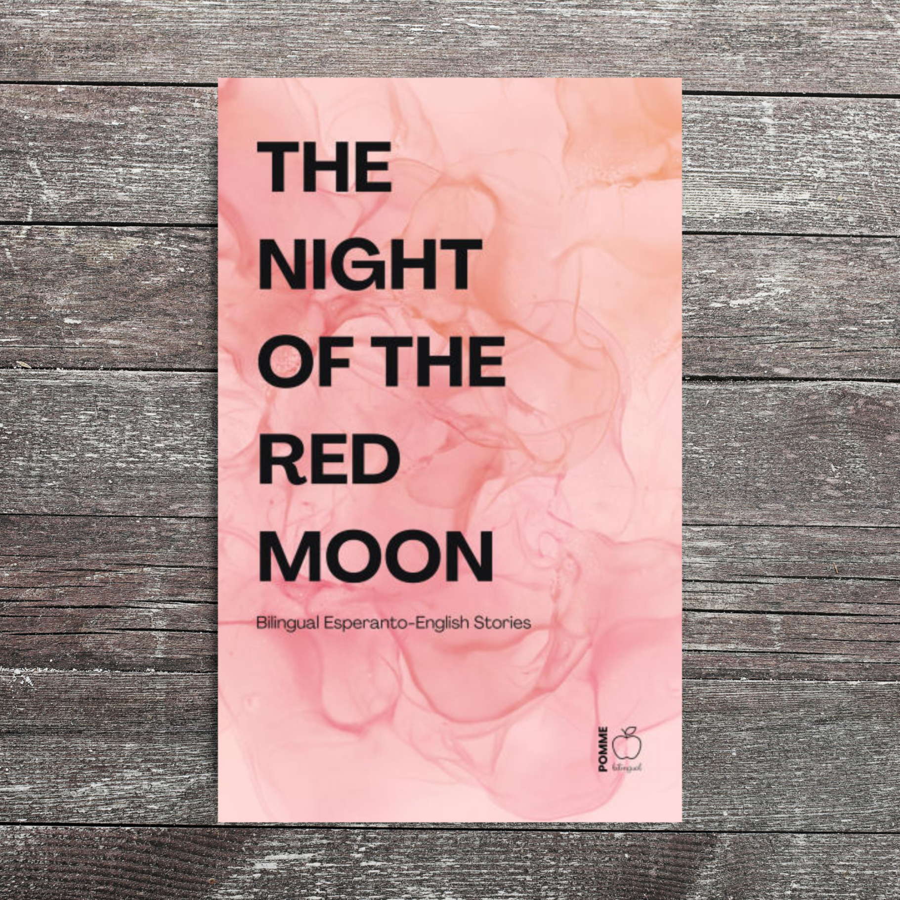 Book cover titled "The Night of the Red Moon" with a pink abstract background.