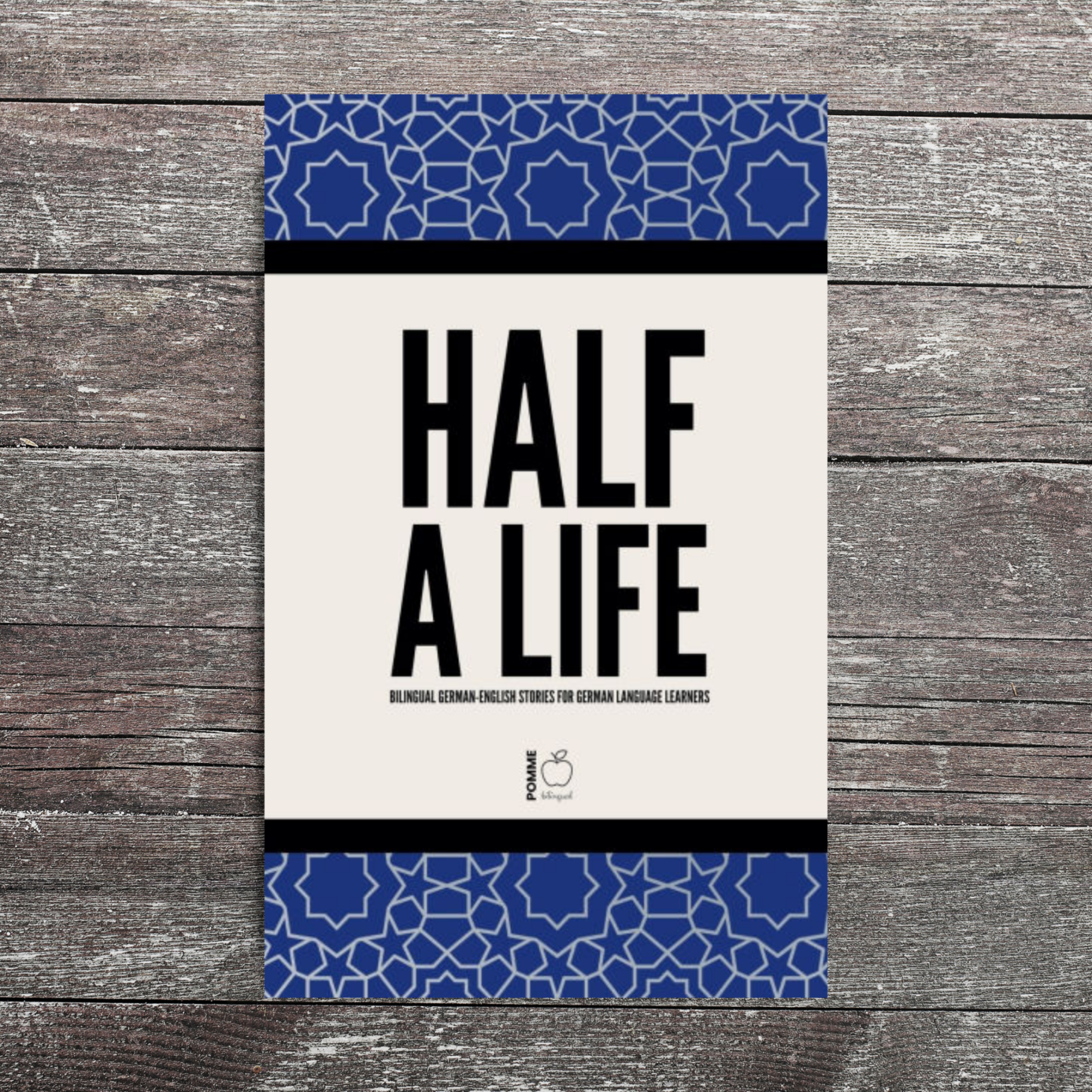 Cover of "Half a Life" featuring bold black text on a patterned blue border.