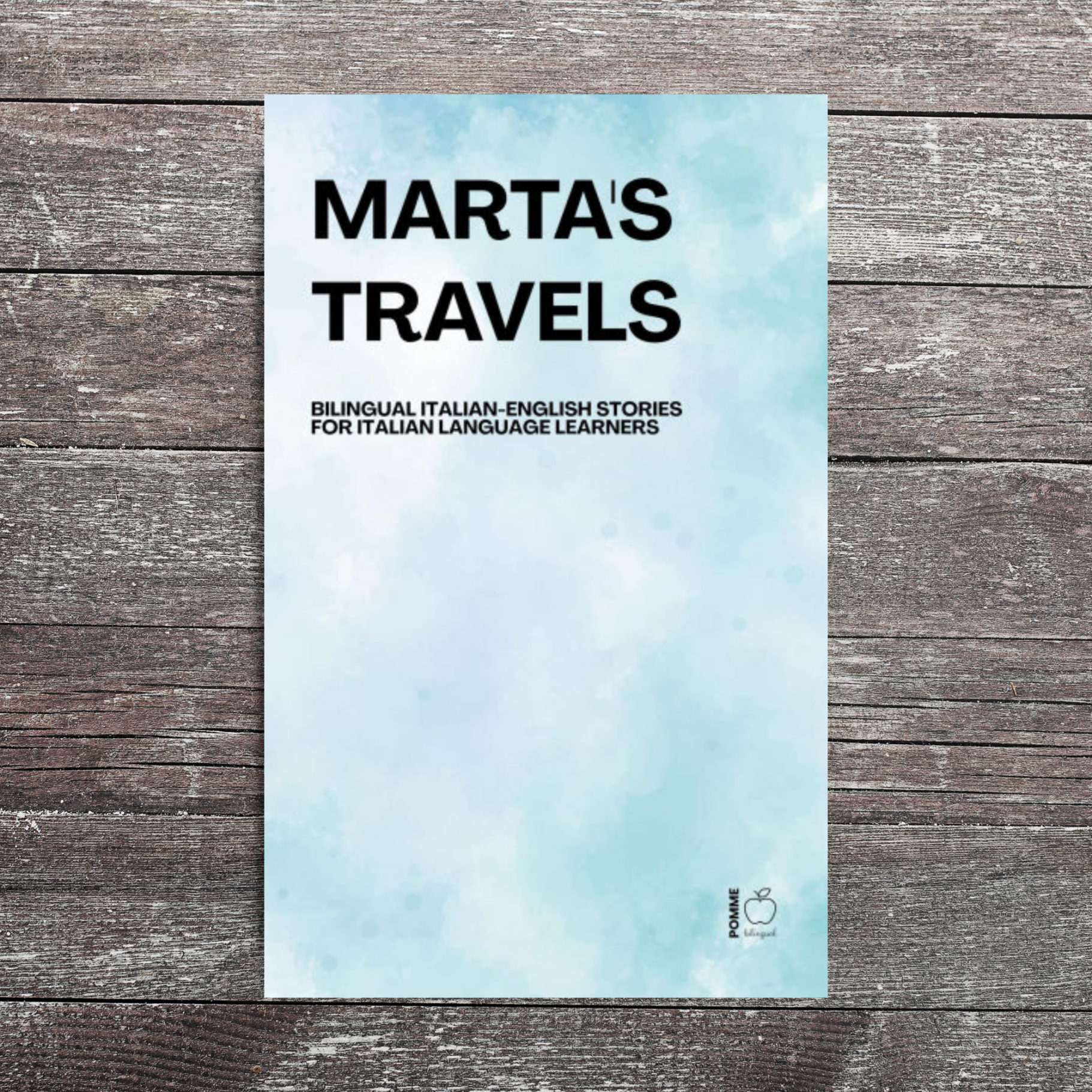 Book cover titled "Marta's Travels" with a blue and white cloud-like background.