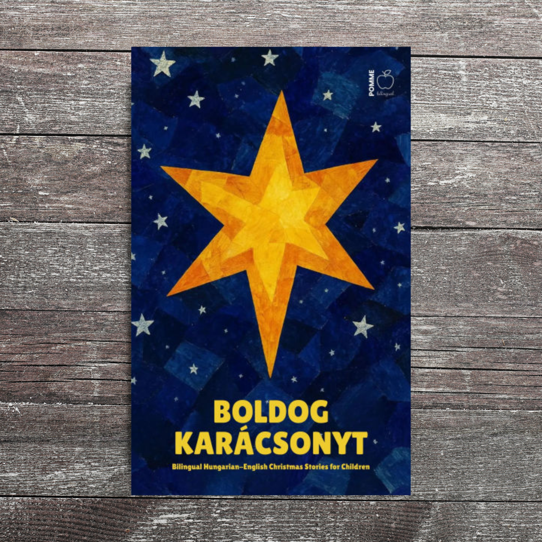 A bright yellow star on a blue background with the text "Boldog Karácsonyt."