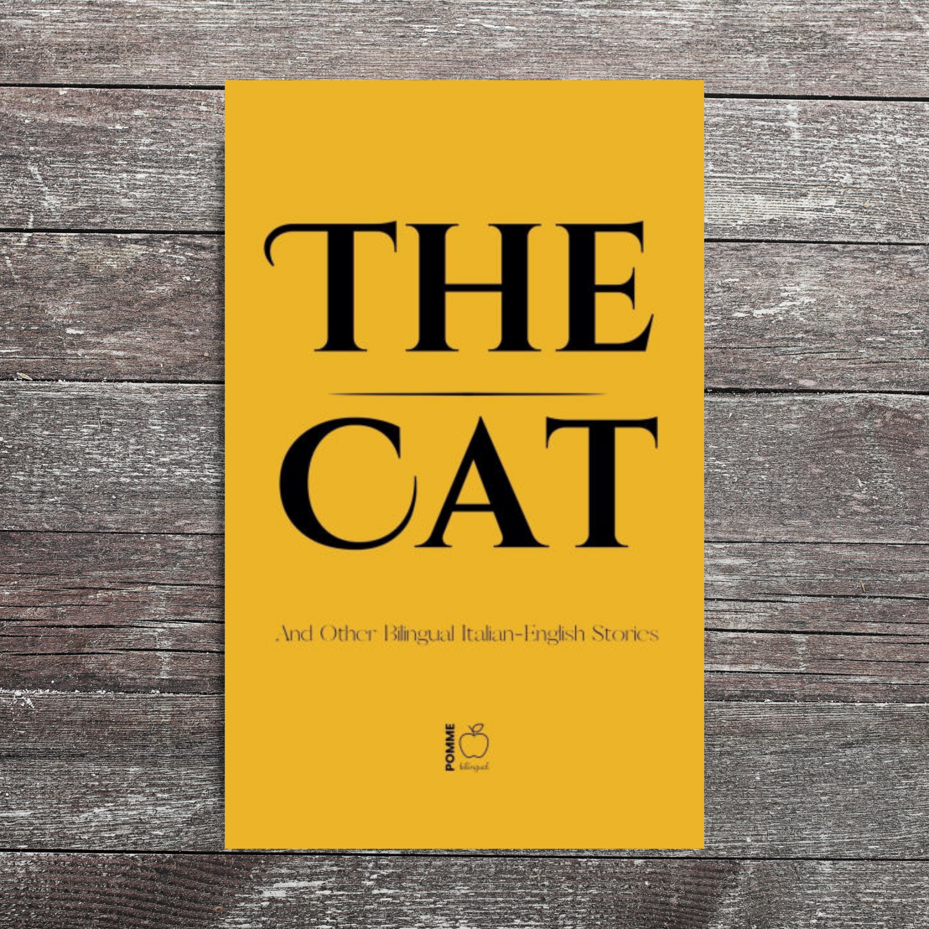 Book cover titled "The Cat" on a wooden background.