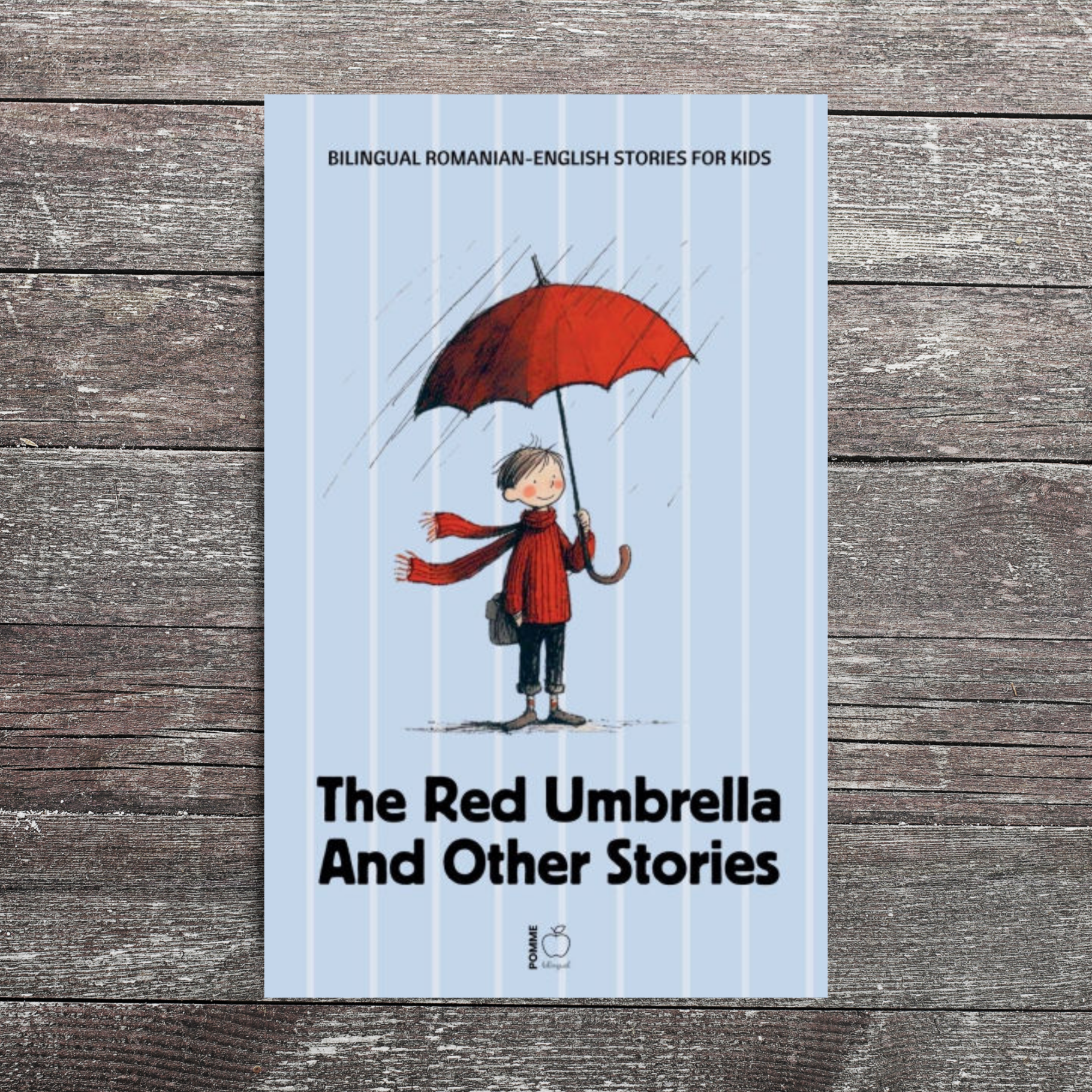 A book cover featuring a child with a red umbrella on a wooden background.