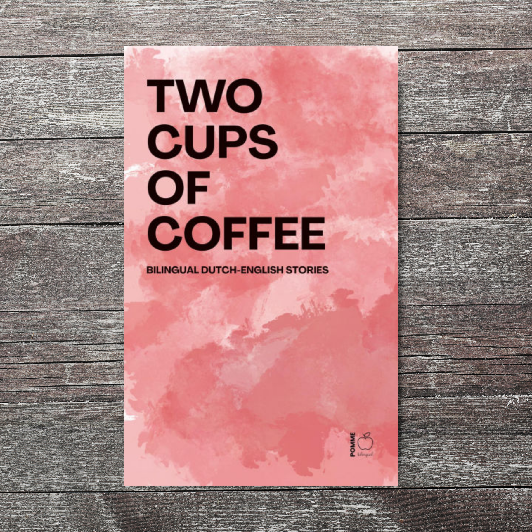 Pink watercolour background with bold text reading "Two Cups of Coffee".